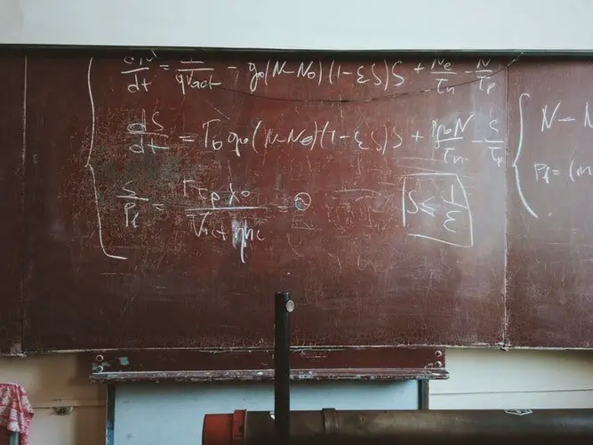 Mathematical equations written on the chalk board